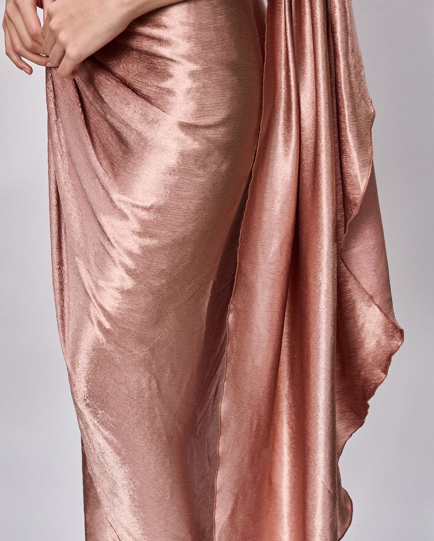Closeup of the drapes of a beautiful rose gold Cocktail dress