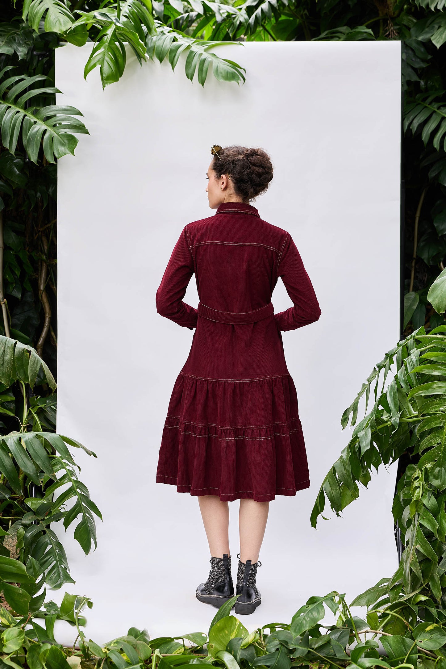 Model wearing Manchester Dress — structured tiered corduroy dress with pockets and metal buttons