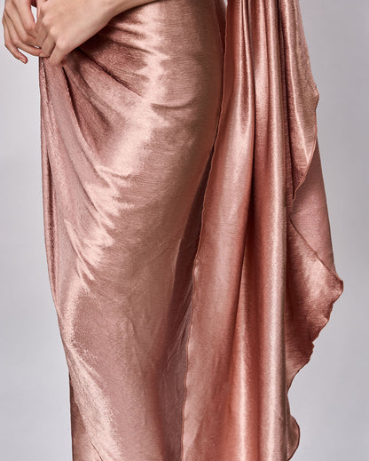 Closeup of the drapes of a beautiful rose gold Cocktail dress
