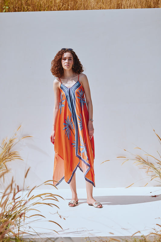 Designer orange dress with asymmetric hem by VA RA – perfect for Indian summer vacations