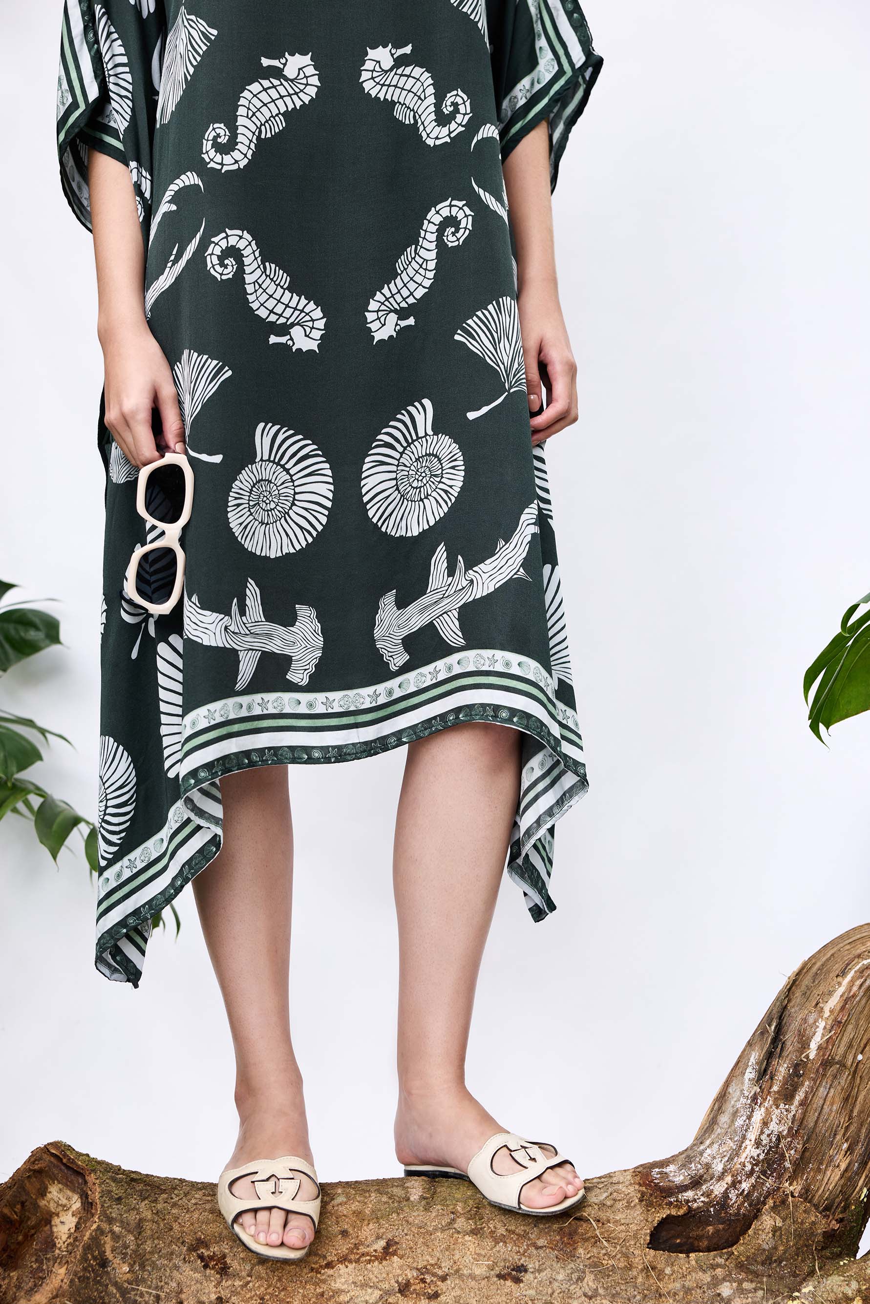 Close-up of She Shell Kaftan — shell-inspired print and handkerchief hemline