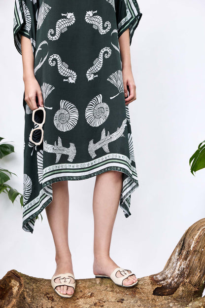 Close-up of She Shell Kaftan — shell-inspired print and handkerchief hemline