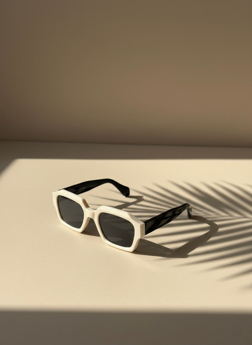 Ivory and black square sunglasses placed beside a cocktail by a poolside —White Negroni Sunglasses
