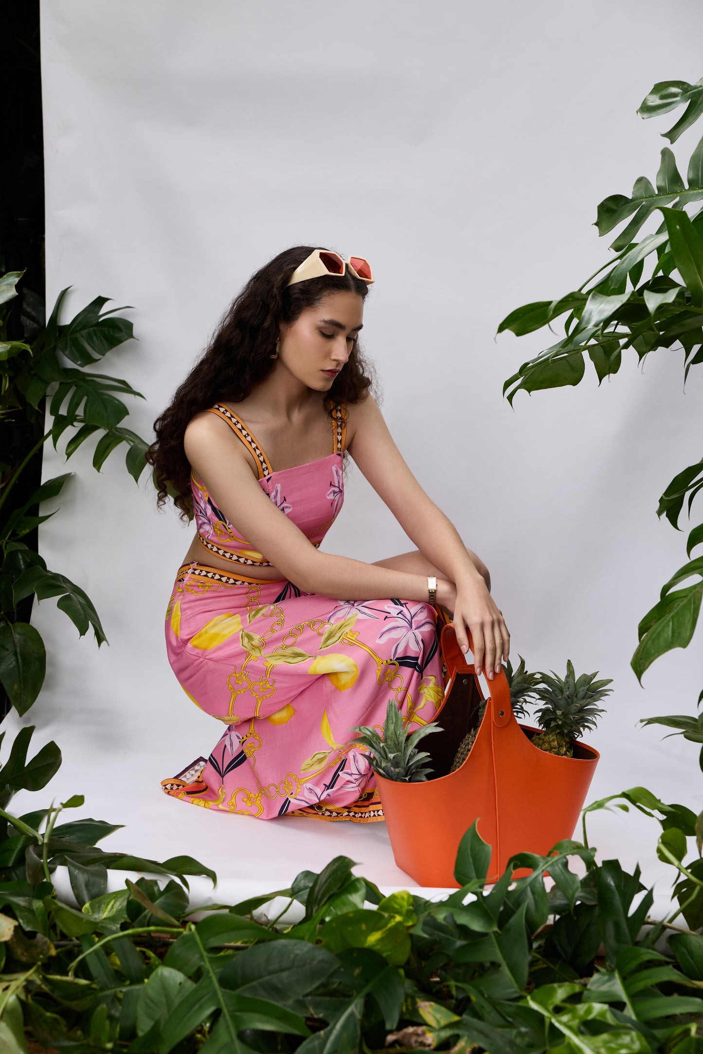Model wearing Lilly Bloom Co-ord Set — resort wear with tropical chain and lily print